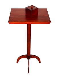 a square wooden table with a box on top