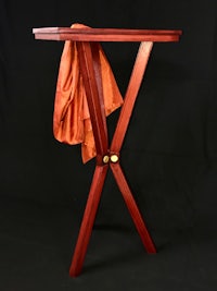 a wooden table with an orange cloth on it