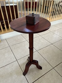 a small wooden table with a box on top