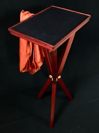 a wooden table with an orange cloth on it